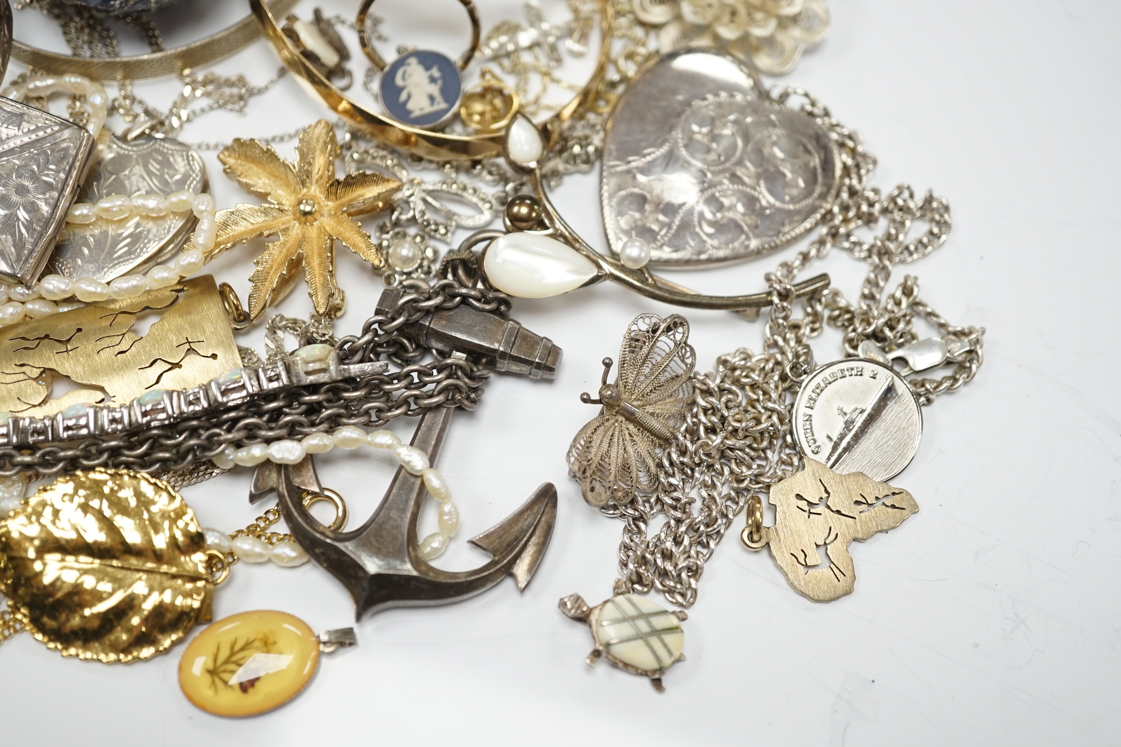 A quantity of assorted costume and silver jewellery including pendants, locket, bracelets, bangles, chains etc.